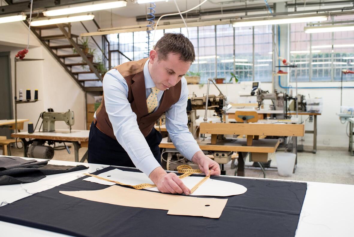 tailor working with paper patterns on new jacket pmn3dyr.jpg